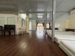 a bedroom with two beds and a wooden floor at Homestay Chân Mây in Tam Ðảo