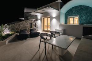 a living room with a table and chairs at Serenity Collection Suites in Karterados