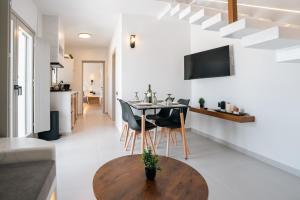 a kitchen and living room with a table and chairs at Serenity Collection Suites in Karterados