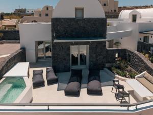 a balcony of a house with a swimming pool at Serenity Collection Suites in Karterados