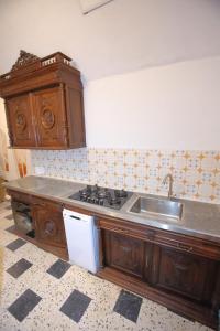 a kitchen with a sink and a stove top oven at chez nous - la une in Marseillan +18 photos