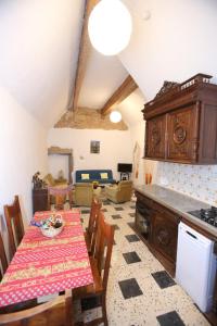 a kitchen and dining room with a table and a room at chez nous - la une in Marseillan
