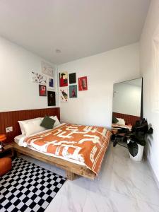 a bedroom with a bed and a mirror on the wall at Tổ Ấm 25 in Da Thanh