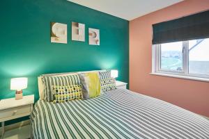 a bedroom with a bed and a green wall at House Sleeps 8 with WiFi in Corby