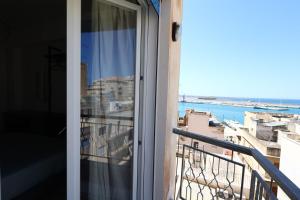 a balcony with a view of the ocean at Ferries apartament in Trapani