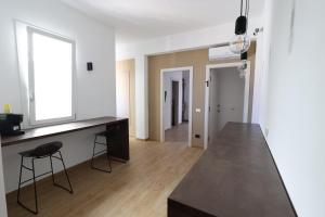 a kitchen with a counter and a table and a window at Ferries apartament in Trapani