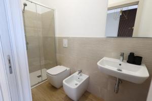 a bathroom with a toilet and a sink and a shower at Ferries apartament in Trapani +27 photos