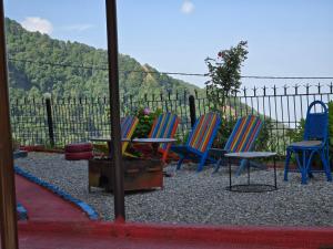a group of chairs sitting in front of a fence at Hotel Monal Inn, Pangot Wildlife and Bird Sanctuary in Nainital