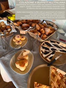 a table with plates of pastries and pies on it at Il Romito in Quercianella
