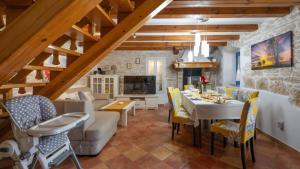 a dining room and living room with a table and chairs at Villa Katarina by Villas Guide in Barban