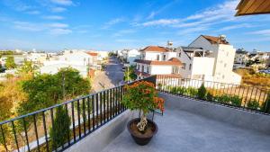 a potted plant on a balcony with a city at Arora Home Pleiku in Pleiku