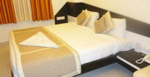 a bedroom with a large bed in a room at SHIVAM Hotel in Muzaffarpur
