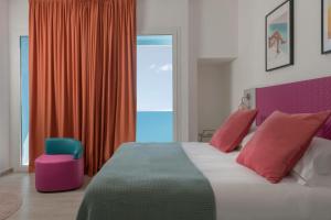 a bedroom with a large bed and a chair at Miramare Resort in Rimini