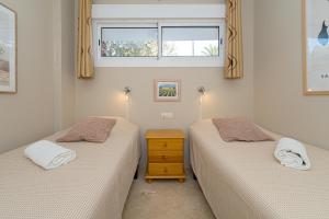 two twin beds in a room with a window at Estrella 2 BA Spaniahome in Albir +25 photos