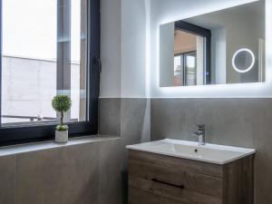 a bathroom with a sink and a mirror at Ferienwelt Wittenberge in Wittenberge +40 photos