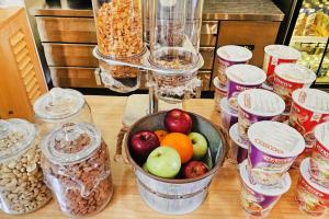 a table topped with a bowl of fruit and nuts at Palmscape Boutique Hotel in Hulhumale