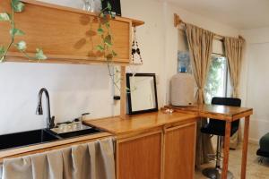 a kitchen with a sink and a wooden counter top at Casa Samay in Cozumel