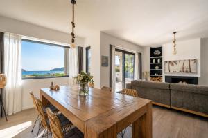 a living room with a wooden table and a couch at Interni Villa by A&D Properties in Porto Rafti