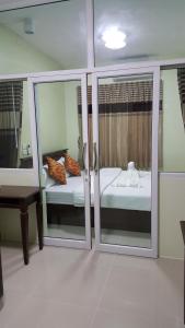a room with sliding glass doors with a bed and a table at The Best Place in Samutprakarn +58 photos