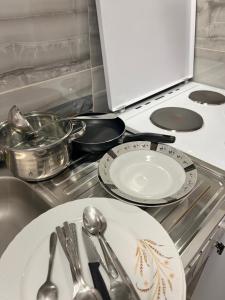 a kitchen with plates and utensils on a stove at PARIS Luxury Center Apartment STRUGA in Struga +12 photos