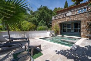 a house with a swimming pool in a yard at Chambres D'hôtes - Le Mas Du Rocher in Hyères