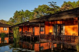 a house with a pond in front of it at ViewPoint Ecolodge in Nyaungshwe Township