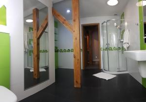 a bathroom with a glass shower and a sink at Pentagos Centrum in Poznań +32 photos