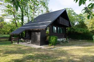 a small cabin with a black roof at Apartma Dobnik in Mozirje