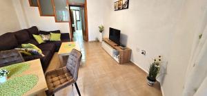 a living room with a couch and a table at Marolesja in Puerto de Mazarrón