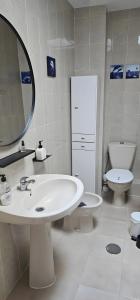 a bathroom with a sink and a toilet and a mirror at Marolesja in Puerto de Mazarrón +23 photos