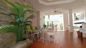 a living room with a table and a plant at Casa Blanca Boutique Hotel - SHA Plus in Phuket