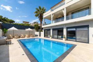 a swimming pool in the backyard of a house at Interni Villa by A&D Properties in Porto Rafti