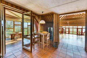 a kitchen with a table and chairs in a room at Haus Habbinga in Ovelgönne
