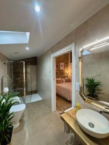 a bathroom with a sink and a tub and a bed at Casa Rural Maria Bargiela in A Picaraña +47 photos