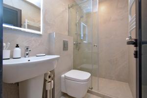 a bathroom with a toilet and a sink and a shower at Chic city apartment I By Domel Yerevan in Yerevan