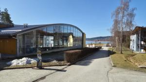 a building with glass windows on the side of a street at Nad Hrází I in Lipno nad Vltavou