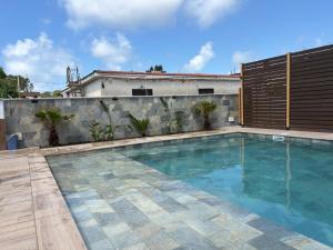 a swimming pool in front of a house at Villa GEMMA in Castel Volturno