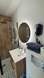 a bathroom with a sink and a mirror at Liwia Park Green House in Niechorze +48 photos