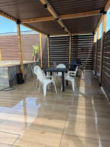 a patio with a table and chairs on a deck at Villa GEMMA in Castel Volturno