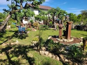 a yard with a garden with a bench and trees at Apartma Tanja bike-friendly in Limbuš