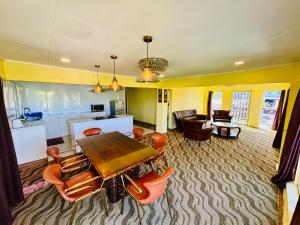 a living room with a wooden table and chairs at A1 Apartments in Suva