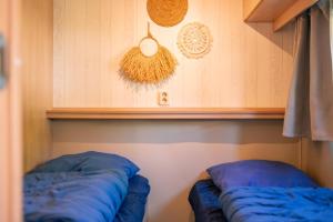two blue pillows sitting on a shelf in a room at Zomerhuisje Chalet in Voorthuizen +16 photos