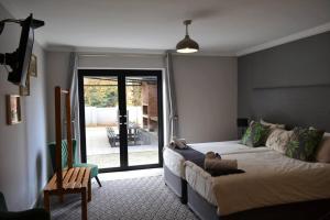 a bedroom with a bed and a sliding glass door at Sleep84 in Dullstroom