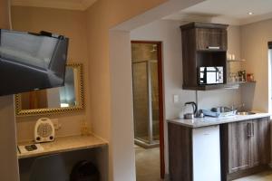 a kitchen with a television and a counter top at Sleep84 in Dullstroom +96 photos