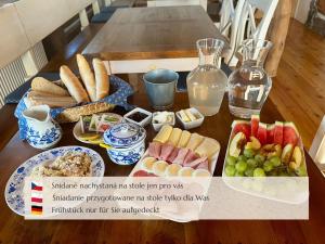 a table with plates of food on a table at Penzion Muštelka in Rokytnice nad Jizerou