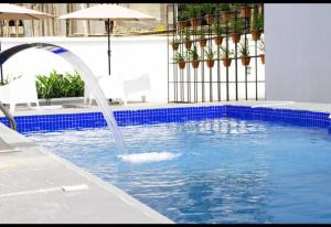 a swimming pool with a fountain in the middle of it at Lekki Waterfront Terrace shortlet with Oceanview, Attendants and private Jetty in Lagos