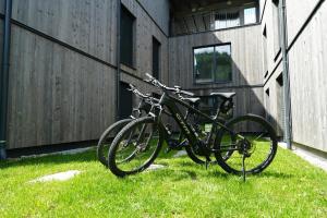 a bike parked in the grass next to a building at Alpenlodge Haus - Summer resort with Schladming-Dachstein Card in Haus im Ennstal +113 photos