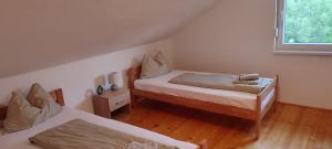 a small bedroom with two beds and a window at Lake House Ceric in Jajce