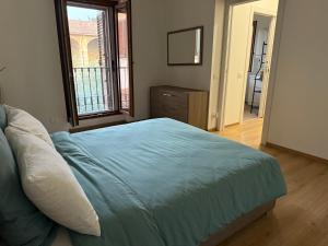 a bedroom with a large bed and a window at Casa di Nina in Grazzano Badoglio