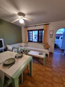 a living room with a couch and a table at Posidonia -Son Bou Apartment in Son Bou +31 photos